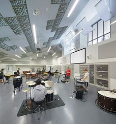 a group of people playing instruments in a large room