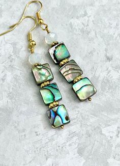 Abalone Moonstone Earrings ☀️ These Earrings have 8/10mm Abalone Shell and 6mm faceted Moonstones... the Earrings measure approximately 2.2 inches long with Gold Plated ear wires... Each piece of Abalone Shell is  unique with naturally beautiful imperfections... You will receive a pair of Earrings similar too but not the same to the earrings in the pictures... the colors may change slightly depending upon the light...  ✨  Visit our Etsy Shop for ....  Turquoise, Agate, Lapis, Coral, Jasper...  and more...  https://www.etsy.com/shop/CrystalHavenDesign 🌻 Iridescent Mother Of Pearl Dangle Jewelry, Adjustable Dangle Earrings In Mother Of Pearl, Earrings Gold Long, Beautiful Imperfections, Abalone Earrings, Earring Ideas, Moonstone Earrings, Ear Rings, Naturally Beautiful