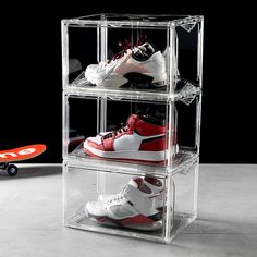 three tiered clear acrylic shoe rack with various pairs of shoes