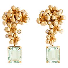 These contemporary 18 karat yellow gold cocktail floral stud earrings are encrusted with 10 round diamonds and detachable prasiolites (light green quartzes). This jewellery collection was featured in Vogue UA review in November. The size of one earring is 3,7x1.7 cm, and the depth without a lock is 5 mm. We use top natural diamonds VS, F-G, we work with german gems company, that is in the market since 19th century. The sculptural design adds the extra highlights to the surface of the gold. The diamonds add the delicate blinks. The gems can be exchanged for another gem drops of tanzanites, rose or lemon quartz, blue topazes or red garnets. These earrings are custom hand made, each gem and a flower is custom placed for each unique copy. You can contact the artist to order them in white, yell Luxury Festive Earrings With Rose Cut Diamonds, Luxury Yellow Gold Cluster Earrings In Flower Shape, Luxury Yellow Gold Pierced Cluster Earrings, Yellow Diamond Earring, Chrome Tourmaline, Flower Places, Purple Cushions, Ruby Earrings Studs, Cocktail Earrings