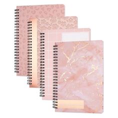 three notebooks with pink marble and gold foil on the cover, one is blank