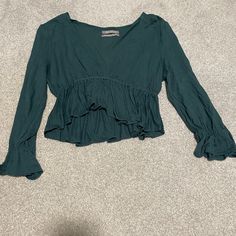 Cropped Dark Green Urban Outfitters Peplum Top. Super Cute And Comfy. Peplum Also On The Sleeves. Deep V Neck And Long Sleeves. Never Worn And Great Condition. Price Negotiable. Last Picture Is The Picture On The Model And The Second Photo Shows The Color The Best. No Rips Of Flaws. Size Medium. Spring V-neck Peplum Top With Ruffle Hem, Green V-neck Top With Ruffles, Bohemian V-neck Top With Ruffle Hem, Spring V-neck Peasant Top With Ruffles, Fall V-neck Top With Ruffle Hem, Long Sleeve Ruffled Top For Brunch, Green V-neck Top For Brunch, Spring Long Sleeve Tops With Ruffle Hem, Bohemian Long Sleeve Tops With Ruffle Hem