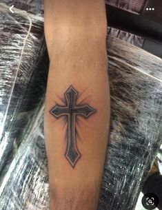 a man with a cross tattoo on his leg