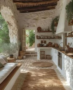 an outdoor kitchen with stone walls and flooring