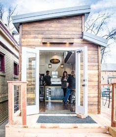 two people standing in the doorway of a tiny house