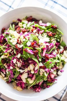 a white bowl filled with red cabbage and almonds