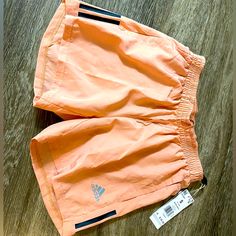 Color Blush Size Small Adidas Athleisure Shorts For Spring, Adidas Pink Shorts For Spring, Adidas Spring Shorts, Adidas Stretch Athletic Shorts For Spring, Pink Athletic Shorts With Pockets For Spring, Adidas Shorts With Pockets For Spring, Peach Bottoms With Pockets For Summer, Peach Shorts For Spring, Adidas Running Shorts