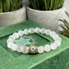 You will ABSOLUTELY LOVE this Beautiful Genuine Selenite Crystal Bracelet with  High Quality CZ Evil Eye Accent Bead. Available in 8mm or 6mm Selenite Choose from Silver or Gold Evil Eye  Selenite is Excellent to keep Negative Energies Away! Selenite - (Crystal for Crown & Third Eye Chakras) This Gorgeous Selenite Bracelet  is a Gift they will ABSOLUTELY LOVE ! ❤️ All Bracelets are Crafted from High Quality GENUINE Gemstone Beads sourced from Reputable Healing Crystal Suppliers. You are buying a Selenite Bracelet, Pyrite Bracelet, Bracelet Gift Box, Bracelet Evil Eye, Zodiac Bracelet, Jewelry Mens, High Vibrational, Selenite Crystal, Crystal Healing Bracelets