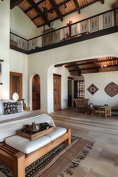 a large bed sitting inside of a bedroom on top of a hard wood flooring