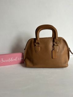 "Vintage Coach Baxter Satchel Soft and supple leather with brass hardware Roomy interior with one zip pocket, one slip pocket Secured by a top zipper Measures: 13\" L, 8\"H, 5 1/2\"W Made in the United States #069-9114 Flaws: Missing long strap, signs of wear shown in photos Cleaned, conditioned and ready to wear! Questions? Just ask More vtg coach styles/colors also available I3" Coach Vintage Handbags, Olive Green Top, Top Handle Bags, Givency Antigona Bag, Coach Leather, Vintage Coach, Vintage Handbags, Vintage Bags, Brass Hardware