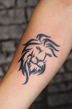 a lion head tattoo on the arm