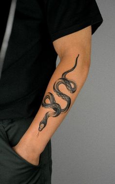 a man with a snake tattoo on his arm