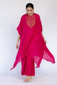 Rani pink kaftan with placed floral embroidered motifs on bodice embellished by sequins. Comes with an inner and matching pant.
Components: 3
Pattern: Embroidered
Type Of Work: Thread, Sequin
Neckline: Round
Sleeve Type: Cape
Fabric: Cotton Silk,Lining: Cotton
Color: Pink
Other Details: 
Flared silhouette
Closure: Kaftan: Back keyhole
Occasion: Sangeet,Mehendi and Haldi - Aza Fashions Pink Zari Work Kaftan For Party, Pink Kaftan For Party Festivals, Elegant Pink Kaftan For Diwali, Pink Kaftan For Party And Festivals, Pink Party Kaftan For Festivals, Pink Kaftan With Dabka Work For Wedding, Pink Zari Work Kaftan For Diwali, Pink Zari Work Kaftan For Weddings, Bollywood Style Pink Saree Kaftan