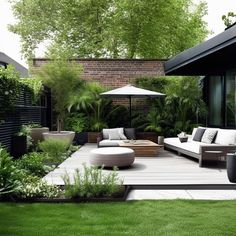 an outdoor living area with couches, tables and umbrellas