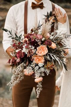 a man holding a bouquet of flowers in his hands