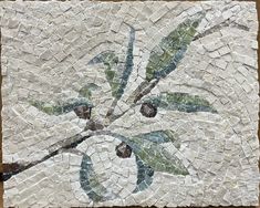 an artistic tile design with leaves on it