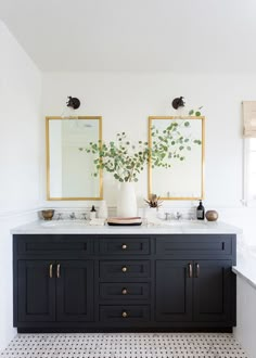 a bathroom with two sinks and mirrors on the wall