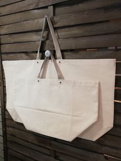 a white bag hanging on a wooden wall