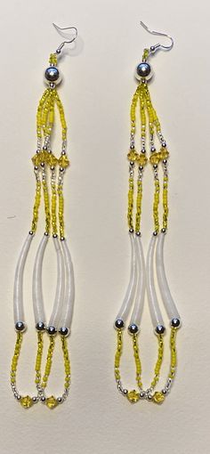 pair of yellow and white beaded earrings with dangling beads on the end of each ear