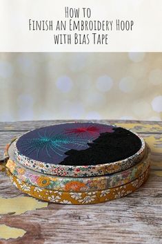 an empty round box sitting on top of a wooden table with text overlay that reads how to finish embroidery hoop with blas tape