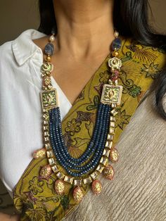 SHIVKA Special. Be Classy, Be Beautiful!! The gorgeous fusion necklace and exclusive earrings are beautifully handcrafted by our skilled Indian craftsmen from Jaipur in gold polish. Material: Blue Sapphire, Kundan, The length of the earrings is 7 cm The drop length of the necklace is 11 inches Necklace comes with hook closure. Notice the Tanjore artwork on cherry quartz beads, Enamelled work on side brooches Exclusive Earrings, Drops Necklace, Be Classy, Cherry Quartz, Quartz Beads, Earrings Statement, Gold Polish, Be Beautiful, Enamel Jewelry