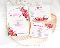 the wedding stationery is on top of a paper plate with pink and yellow flowers