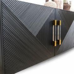 a black and gold cabinet with two handles