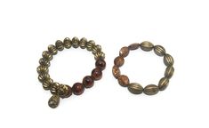 This item is a pair of vintage gold tone and brown beads elastic beaded bracelets. These bracelets are 7 1/2 inches. Wear together, alone, or stacked with other bracelets for a different look.   DETAILS: ☼ Approximately 7 1/2 inches. ☼ Approximately 38.6 grams, total weight. ☼ ☼ ☼ ☼ ☼ ☼ ☼ ☼ ☼ ☼ ☼ ☼ ☼ ☼ ☼ ☼ ☼ ☼ ☼ ☼ ☼ PLEASE NOTE:  ☼ Different items on SALE everyday!  Check back often to take advantage of these bargains! ☼ FREE DOMESTIC SHIPPING on purchases of $35 or more. Combined shipping is st Vintage Gold Stretch Bracelet With Round Beads, Vintage Gold Beaded Stretch Bracelet, Bohemian Gold Stretch Bracelet With Wooden Beads, Elastic Beaded Bracelets, Favorite Pins, Vintage Gold, Vintage Jewelry, Porter, Jewelry Bracelets