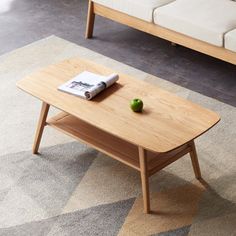 a wooden table sitting on top of a carpeted floor next to a couch and coffee table