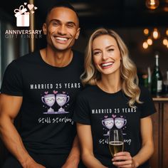 a man and woman wearing matching t - shirts holding champagne glasses in front of them