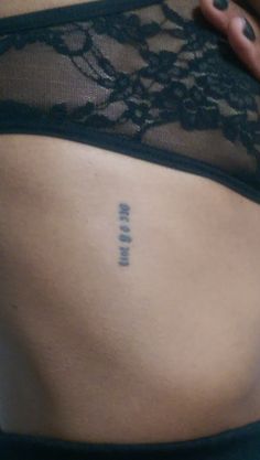 the back of a woman's stomach with an inscription on it