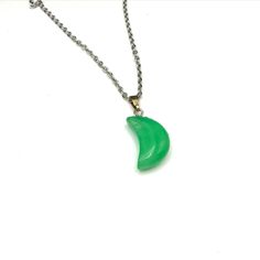 Elegant necklace featuring a green jade crescent moon pendant on a silver tone chain. Ideal for adding a touch of sophistication to any outfit. * Green jade crescent moon pendant * Silver tone chain * Lobster clasp closure * Pendant approximately 1 inch * Chain approximately 18 inches item# Z24179 Gently loved Thank you for visiting our shop... Green Moon Charm Round Necklace, Green Necklace With Moon Charm, Green Moon Charm Necklace, Green Crescent Moon Charm Jewelry, Crescent Moon Pendant, Crescent Moon Necklace, Elegant Necklace, Elegant Necklaces, Jade Pendant