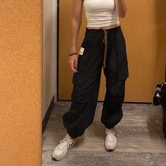 Cool In Cargo, These Sporty Pants Are A True Timeless Staple. Fit: Mid-Rise, Tapered Fit And Classic Cargo Silhouette Features: Smocked Waistband With Drawstring Detail, Cargo Pockets Throughout, Banded Hemlines, Sleek Nylon Fabrication Why We <3 It: Just As Effortless As They Are Versatile, These Pants Have Endless Ways To Wear. Pockets In The Back Too! Windbreaker Pants, Sporty Pants, Drawstring Detail, Free People Pants, Track Pants, Smocking, Pant Jumpsuit, Mid Rise, Free People