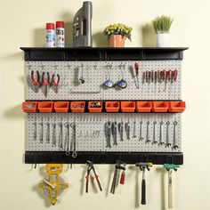 a wall mounted tool rack filled with lots of tools