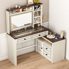 a white desk with a mirror and some drawers