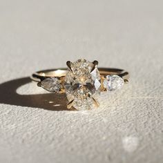 three pear shaped diamond rings sitting on top of each other