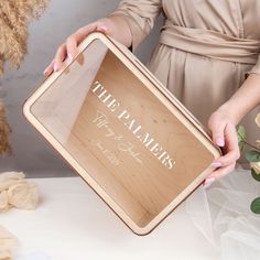 a woman holding a wooden sign with the words free planners on it and flowers in front of her