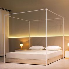 a bed with a white canopy over it in a room next to two nightstands