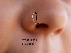 a nose piercing with an arrow pointing to the right, and what is the distance?