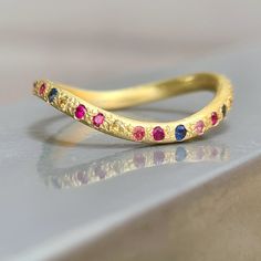 Sapphire full eternity band - A wavy, flowing ring in rich 18k gold, set with beautiful multi colored sapphires. Its round profile makes the ring very comfortable to wear, and looks great with other rings in a stack. The band is 2 mm thick, and is lovingly handcrafted and forged by me. It would make a beautiful engagement ring, wedding band or diamond enhancer ring! This gold wave ring is READY TO SHIP in a size 6 3/4 If you need a different size let me know, and a new custom ring will be made t Gold Sapphire Eternity Band As Gift, Yellow Gold Multi-stone Sapphire Promise Ring, Promise Yellow Gold Multi-stone Sapphire Ring, Promise Multi-stone Sapphire Ring In Yellow Gold, Hand Forged Ruby Ring For Anniversary, 14k Gold Multi-stone Eternity Band As Gift, Multi-stone 14k Gold Eternity Band For Anniversary, 14k Gold Multi-stone Eternity Band For Anniversary, Unique Yellow Gold Sapphire Ring For Anniversary