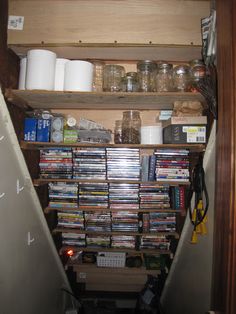 the shelves are full of various items and things to collect in their storage area, including toilet paper