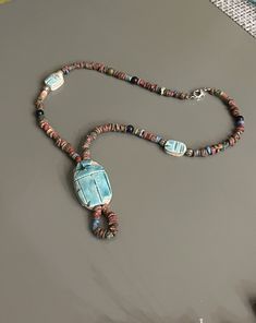 Ethnic necklaces show a piece of history and nature.  Jewelry that's handcrafted by Stringing together natural wooden beads and a handmade pendant and beads, this is truly a showcase piece! * 18" long * carved stone beads 1/2" long by 1/4" wide * carved stone pendant 1/4" tall by 3/4" wide, hangs 2 1/4" long from necklace  * closes with a current lobster claw clasp    * All of my home decor and jewelry is delivered to you in a secure bubble wrapped envelope or box.       * My JEWELRY is shipped in a beautiful jewelry box tied with a bow, ready for gift giving (even if it's just for you!) All you have to do is add a gift card!  How could gift giving be easier?  The box and bow are my choices.     * My HOME DECOR items are sandwiched between heavy cardboard or foam to keep them safe from bre Handmade Amulet Beads For Meditation, Wooden Beads Amulet Necklace For Gift, Wooden Beads Amulet Jewelry For Meditation, Wooden Beads Amulet Necklace As A Gift, Amulet Style Wooden Beaded Necklace For Gifts, Amulet Style Wooden Beaded Necklace As Gift, Amulet Style Wooden Beaded Necklaces For Gifts, Handmade Unique Pendant Beads, Meditation Amulet With Wooden Beads