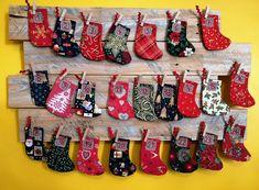 christmas stockings hung on a wooden board with pegs attached to the wall and hanging from hooks