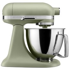 a green mixer with a metal bowl on it's side and a silver handle