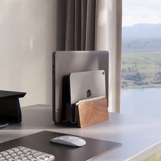 an apple computer sitting on top of a desk next to a keyboard and mouse pad