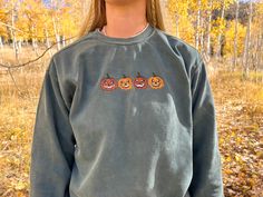 This is a one of a kind embroidered sweatshirt that your gonna absolutely love. This is the perfect gift! HOW TO ORDER Select your sweatshirt size from the first dropdown menu.  To send a sweatshirt directly to the recipient, please mark "This order is a gift" at checkout and include a gift message. SHIPPING  Your sweatshirt will ship within 4-7 business days. All shipments include a tracking number via USPS. All the shipping information will be sent to your email. If you need it by a certain da Halloween Long Sleeve Sweatshirt With Custom Embroidery, Halloween Embroidered Streetwear Top, Long Sleeve Halloween Sweatshirt With Custom Embroidery, Long Sleeve Sweatshirt With Custom Embroidery For Halloween, Long Sleeve Custom Embroidered Sweatshirt For Halloween, Halloween Streetwear Embroidered Top, Fall Crew Sweatshirt With Custom Embroidery, Halloween Embroidered Long Sleeve Tops, Fall Crew Neck Sweater With Custom Embroidery