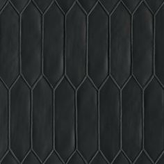 a black tile wall with hexagonal shapes