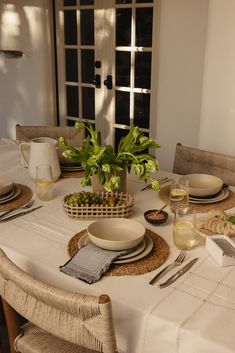 a table set for two with plates and bowls