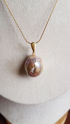 With a hint of gold, this baroque pearl pendant is 20mm x 16mm (approx.) with a gold-filled bail. Pearls vary slightly due to natural qualities of baroque. They are very appealing. Wonderful gift for a bride. Handmade Pear-shaped Gold Necklace, Gift For A Bride, Pearl Anniversary, Baroque Pearl Pendant, Pearl Crafts, Coral Beads Necklace, Real Pearl Necklace, Gold Baroque, Baroque Pearl Necklace