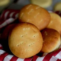 three buns sitting on top of a red and white checkered cloth